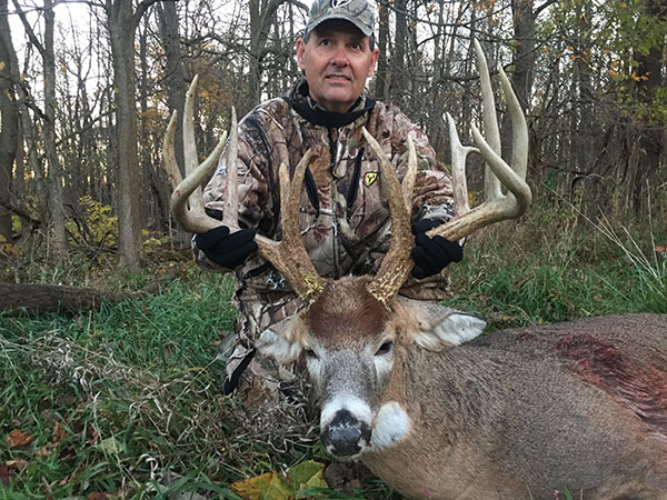 Chris Collins poses with the record book buck he shot in Marshall County.