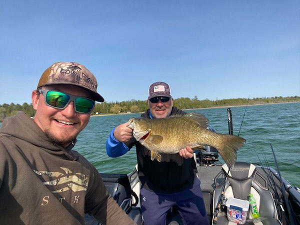 Cody Johnson (left) takes a selfie of him and Todd Vydick with his 9-pound Michigan smallmouth.
