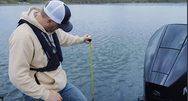 Boat owner calibrating depth finder