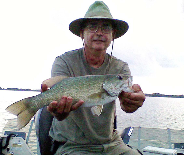 Gary LaRue shows an 18-inch smallmouth he caught at Hurshtown Reservoir.