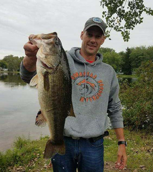 Chad Luthringer shows off the 6.44-pound bass he and Greg Peters caught at Pipestone Lake in the Big Bass Challenege tournament recently.